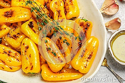 Roasted bell pepper with olive oil, garlic, thyme and spices close up Stock Photo