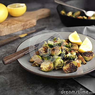 Roasted brussels sprouts portion. Healthy, homemade vegan food or loose weight. Dark background, square image Stock Photo