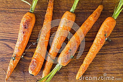 Roasted carrots on a black cast iron skillet Stock Photo