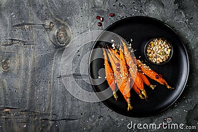 Roasted carrots with dukkah. Vegetarian food. Top view, flat lay. Stock Photo