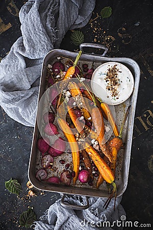 Roasted Carrots, Roasted Radishes with Dukkah Spice and Feta Cheese Sauce Stock Photo