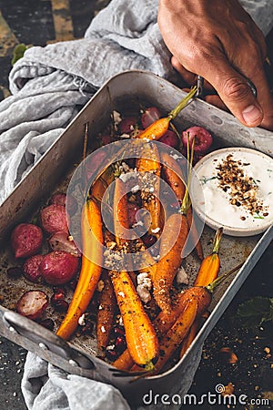 Roasted Carrots, Roasted Radishes with Dukkah Spices and Feta Cheese Sauce Stock Photo