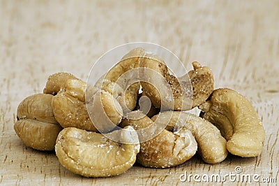 Roasted cashew nuts on an old wooden table. Stock Photo