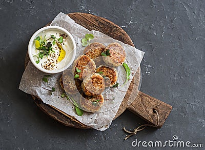 Roasted cauliflower meatballs and greek yogurt sauce on a wooden board, top view. Stock Photo