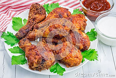 Roasted chicken with celery and carrot sticks, blue cheese dressing and hot sauce Stock Photo