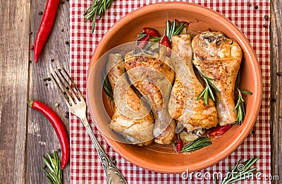 Roasted chicken legs with rosemary, garlic and red chili pepper Stock Photo