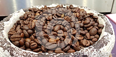 roasted coffee beans close up in stone bowl in business convention centre Stock Photo