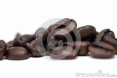 Roasted coffee beans isolated on white background. Close-up image Stock Photo