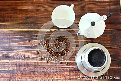 Roasted coffee beans with coffee mocka pot on retro wood floor Stock Photo