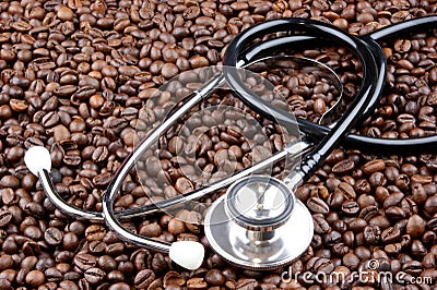 roasted coffee beans and a stethoscope Stock Photo