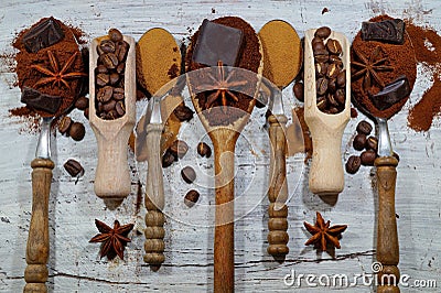 Roasted coffee, ground, beans and instant coffee on vintage spoons with the Addition of pieces of chocolate and spices Stock Photo