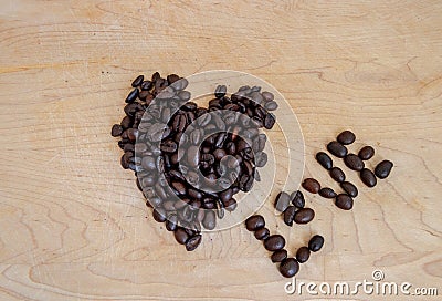 Roasted coffee shaped into heart and spelling the word love - image Stock Photo