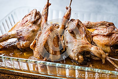 Roasted Crispy Quail Meat in Glass Bowl / Fried Small Chickens. Stock Photo