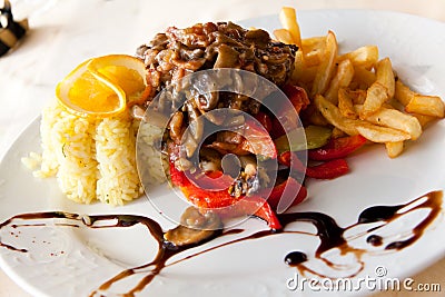 Roasted cutlet of veal with mushrooms and french f Stock Photo