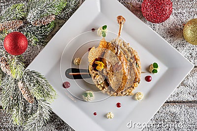 Roasted duck leg with mash and sauce on white plate, christmas traditional food Stock Photo