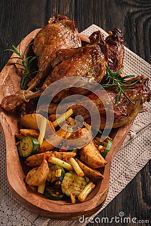 Roasted duck legs with apples and cranberries, served with vegetables. Stock Photo