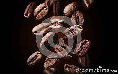 Roasted falling or flying coffee beans on black background, close up, brown texture Stock Photo