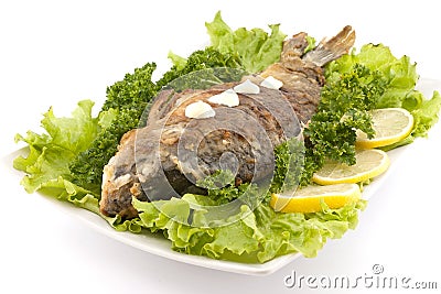 Roasted fish with fresh herbs and lemon. Selective focus Stock Photo