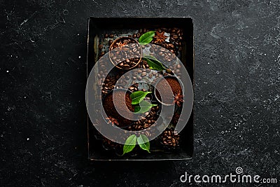 Roasted fragrant coffee beans on a black stone background. Top view. Free space for your text Stock Photo