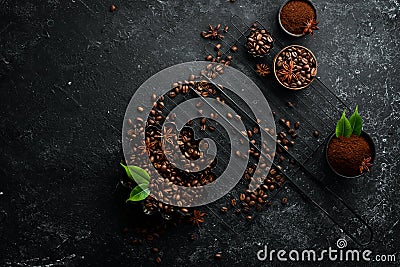 Roasted fragrant coffee beans on a black stone background. Top view. Stock Photo