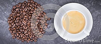 Roasted fragrant coffee grains and hot coffee with milk Stock Photo