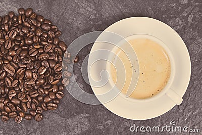 Roasted fragrant coffee grains and coffee with milk. Vintage photo Stock Photo