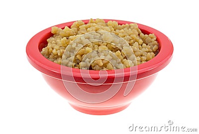 Roasted garlic in a small bowl on a white background Stock Photo