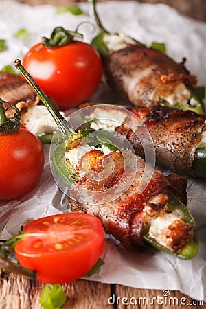 Roasted jalapeno peppers stuffed with cheese wrapped in bacon cl Stock Photo