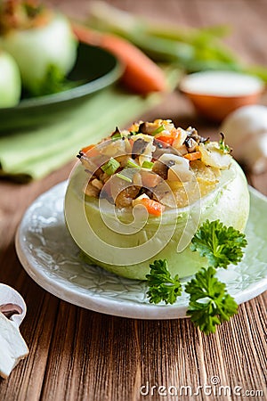 Roasted kohlrabi stuffed with mushrooms, onion and carrot Stock Photo