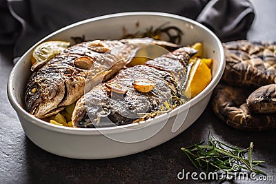 Roasted mediterranean fish bream with potatoes rosemary and lemon Stock Photo