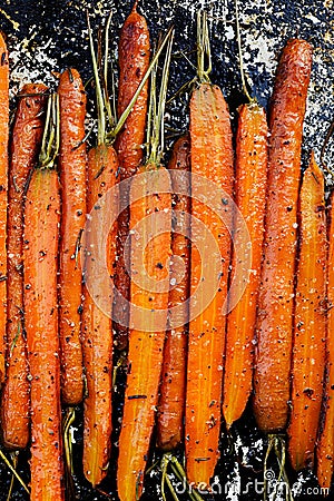 Roasted organic carrots with herbs Stock Photo