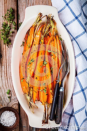 Roasted organic carrots with thyme Stock Photo