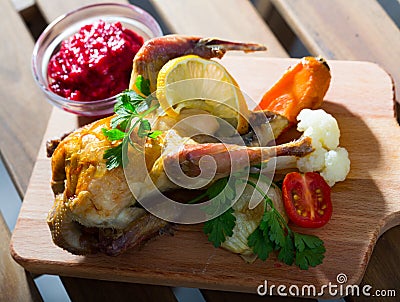Roasted partridge with cranberry sauce Stock Photo