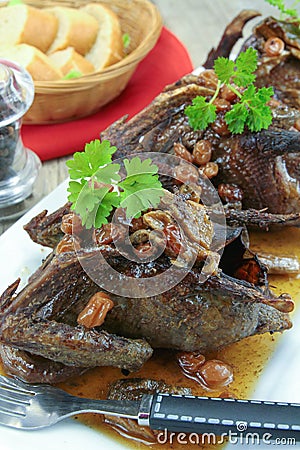 Roasted pigeon with currants Stock Photo