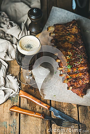 Roasted pork ribs with garlic, rosemary and glass of beer Stock Photo