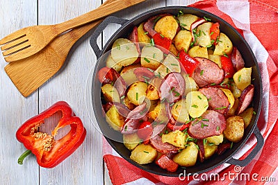 Roasted potato wedges with ham in pan Stock Photo