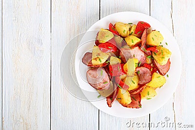 Roasted potato wedges with sausages, top view Stock Photo