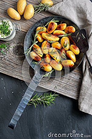 Roasted potatoes in an iron frying pan Stock Photo