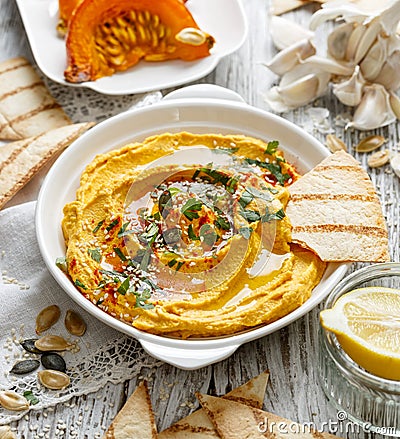 Roasted pumpkin hummus, creamy and delicious dip on a white plate Stock Photo