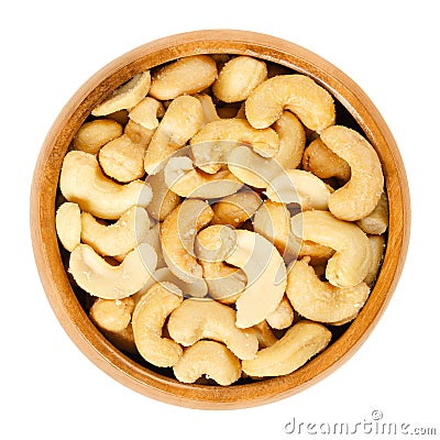 Roasted salted whole cashews in wooden bowl over white Stock Photo