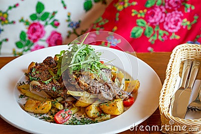 Roasted sheep meat with potatoes and beans Stock Photo