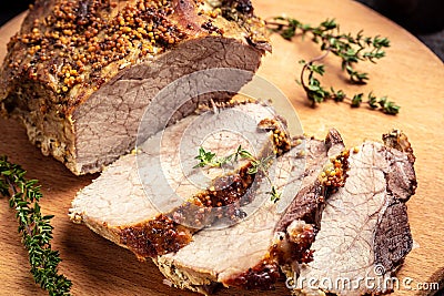 Roasted shoulder on a cutting board, Roasted Christmas ham of turkey. large piece of baked pork with mustard Stock Photo