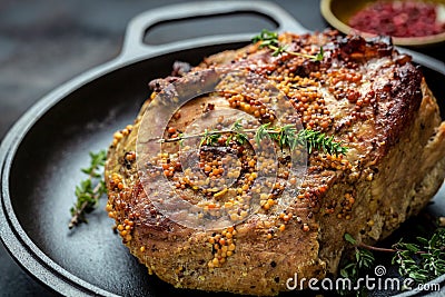 Roasted sliced Christmas ham of turkey. large piece of baked pork with mustard on pan. Festival food recipe background. Close up. Stock Photo