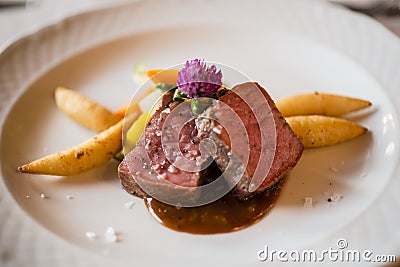 Roasted tagliata beaf with fried potatoes. Stock Photo