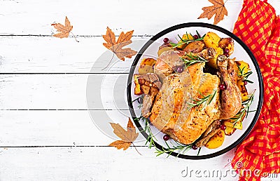 Roasted turkey garnished with cranberries on a rustic style table decorated autumn leaf. Thanksgiving Day. Baked chicken. Top Stock Photo