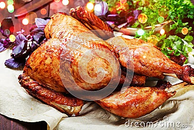 Roasted Turkey. Thanksgiving table served with turkey, decorated with greens and basil on dark wooden background. Homemade food Stock Photo