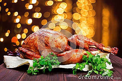 Roasted Turkey. Thanksgiving table served with turkey, decorated with greens and basil on dark wooden background. Homemade food Stock Photo