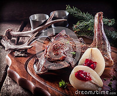 Roasted Vension Haunch Served on Wooden Tray Stock Photo