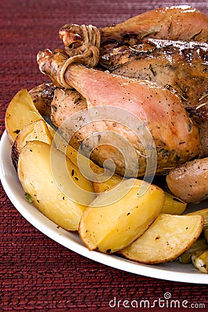 Roasted whole chicken on a plate Stock Photo