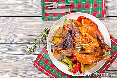 Roasted whole chicken, potatoes, baby carrots, eggplants, green Stock Photo
